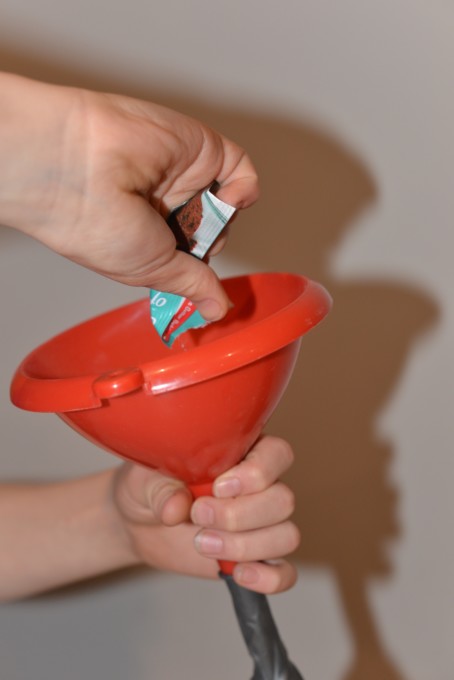 Pour baking soda into a balloon through a funnel - Blow up a balloon with lemon juice