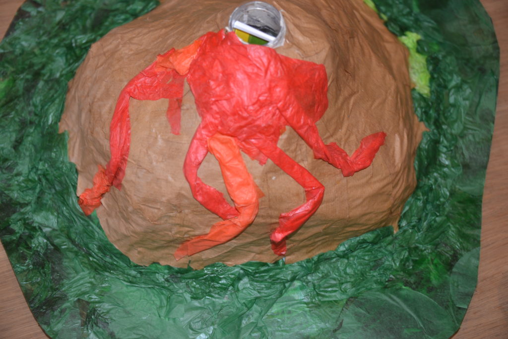 Paper mache volcano made with brow paper and red tissue paper.