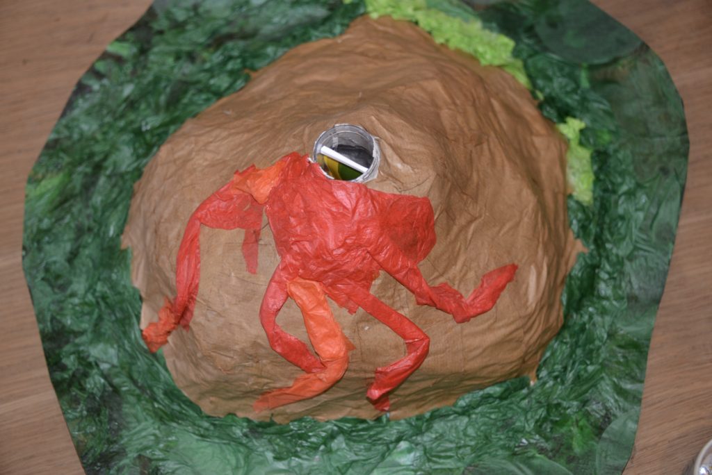 Volcano model for a school science project. Model made with paper mache and coloured tissue paper.