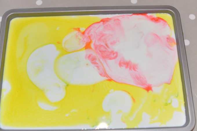 Magic Milk Experiment - a tray filled with milk and explosions of coour