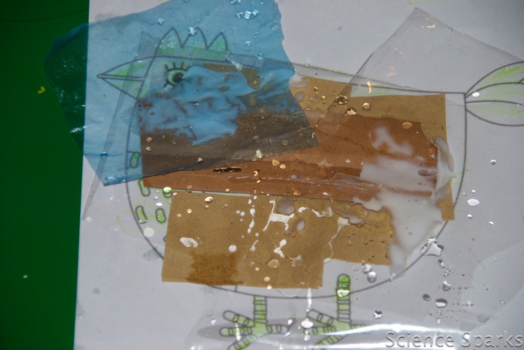 waterproofing chicken drawing on paper. The paper is covered in different types of materials and water has been sprinkled on top