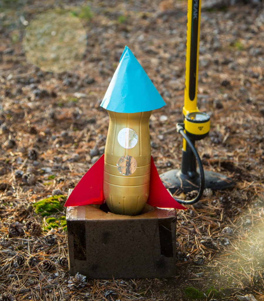 water powered bottle rocket sat in a cardboard box ready to launch