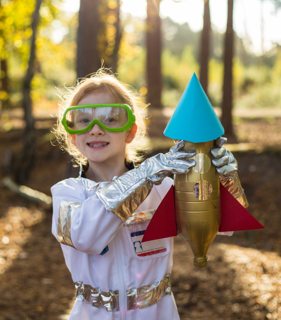 Image of a child holding a bottle rocket