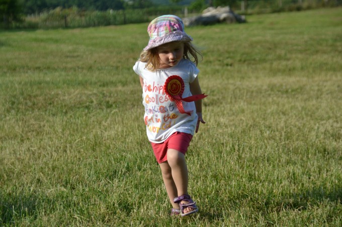 Child running in a field for a heart rate science experiment
