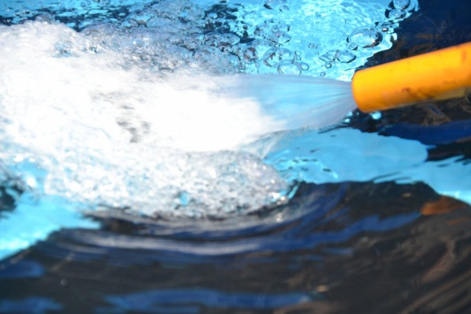 Image of a hose spraying water - paddling pool science for kids