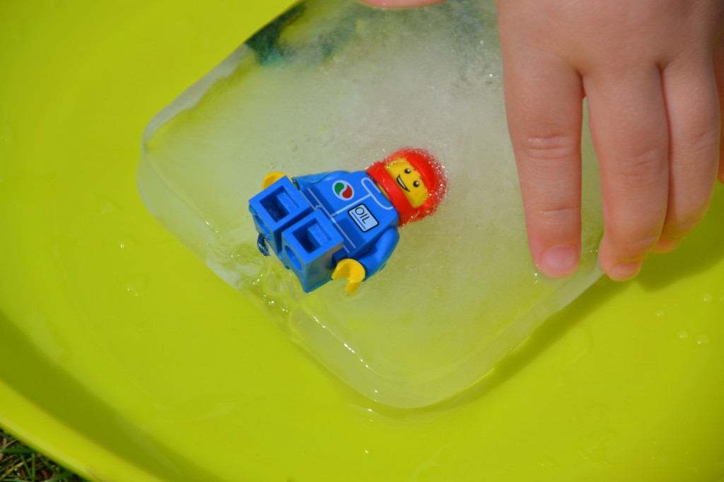 Lego man frozen in a giant ice cube for an ice excavation STEM challenge