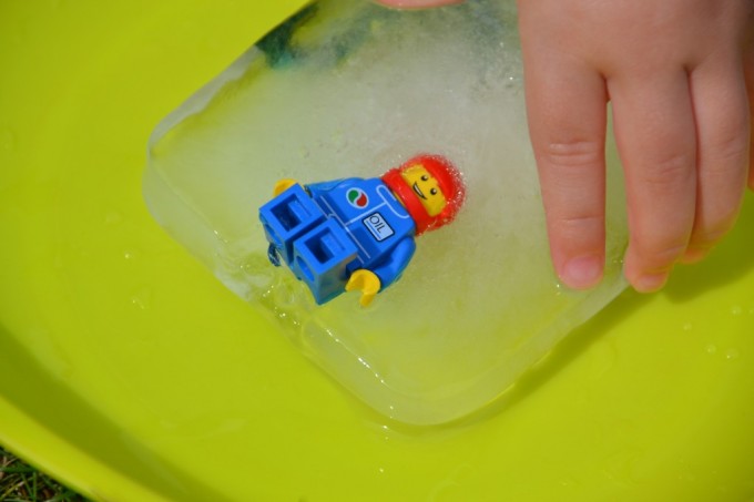 Lego man frozen in ice - fun ice excavation for kids as part of a selection of activities using ice for toddlers.