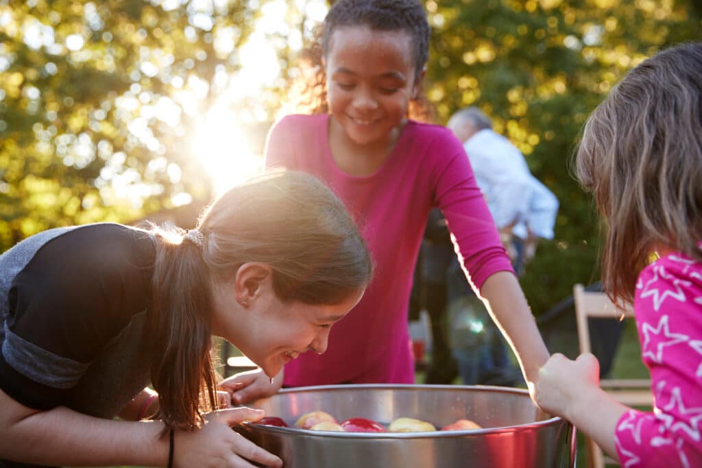 Children playing an apple bobbing game