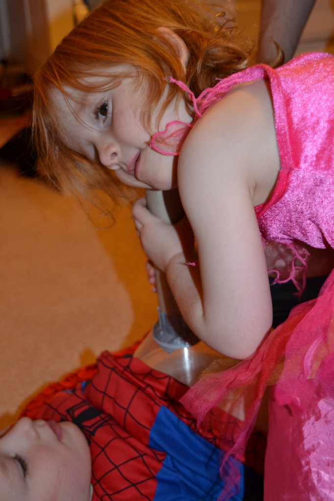 Image of a child using a DIY stethoscope to listen to a young boys chest.