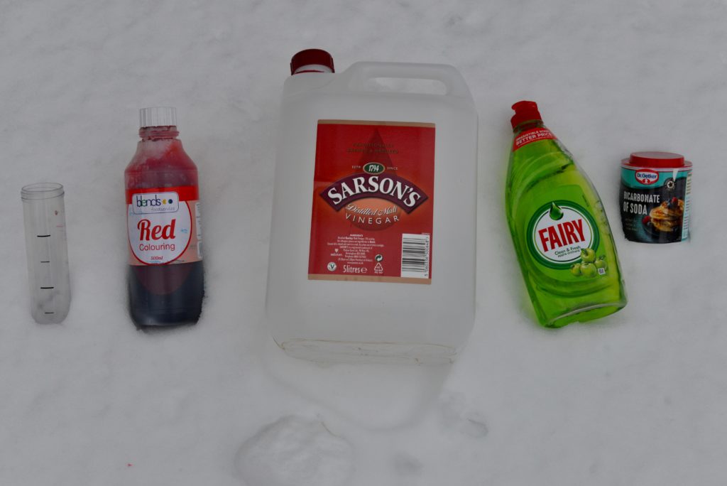 Snow Volcano materials - everything you need to make a snow volcano. Image shows vinegar, red food colouring, dish soap, test tube and baking soda