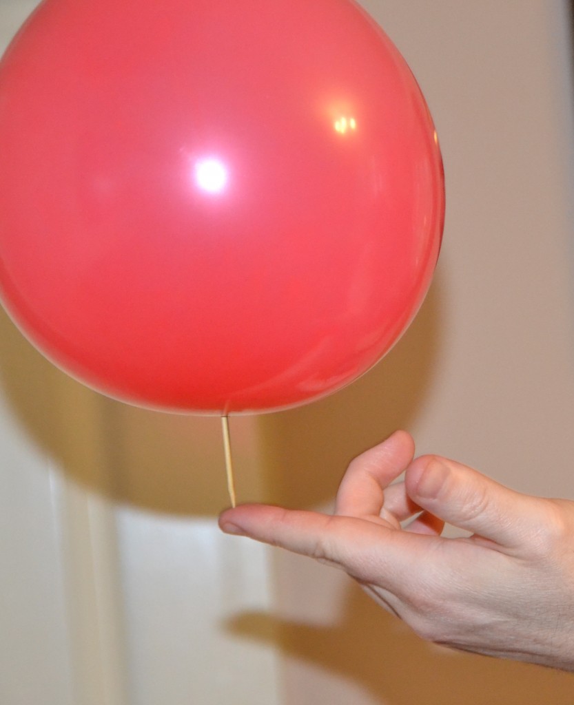 Wooden skewer pushed through a balloon as a science demonstration.