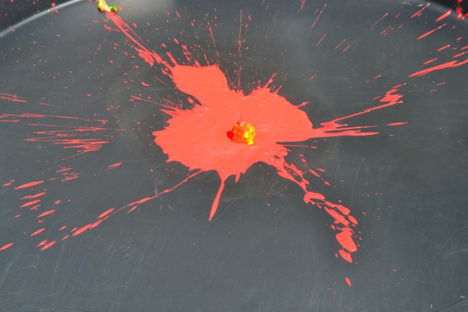 red splatter pattern in a black tray for a science experiment