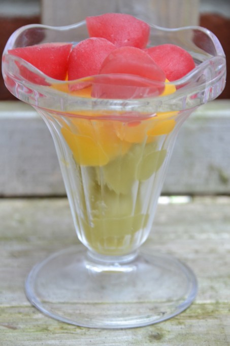 Different coloured smoothies made into ice cubes stacked in a glass for learning about changes of state. 