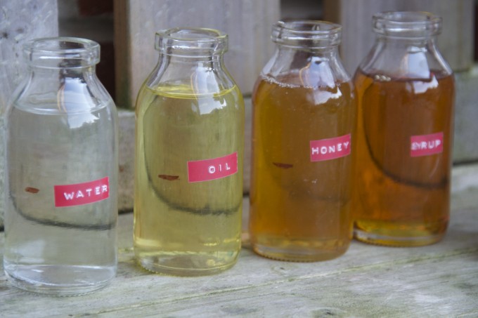 Viscosity experiment using jars containing different liquids