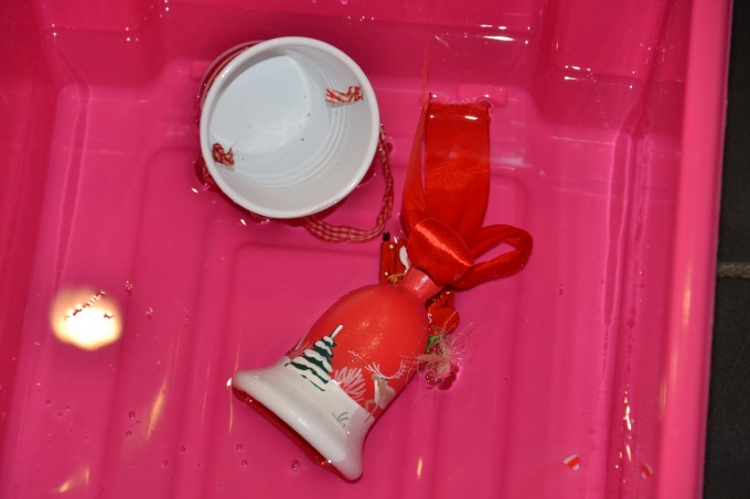 Christmas decorations floating in a box of water