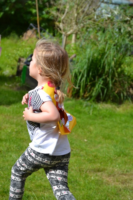 child running wearing a DIY superhero cape