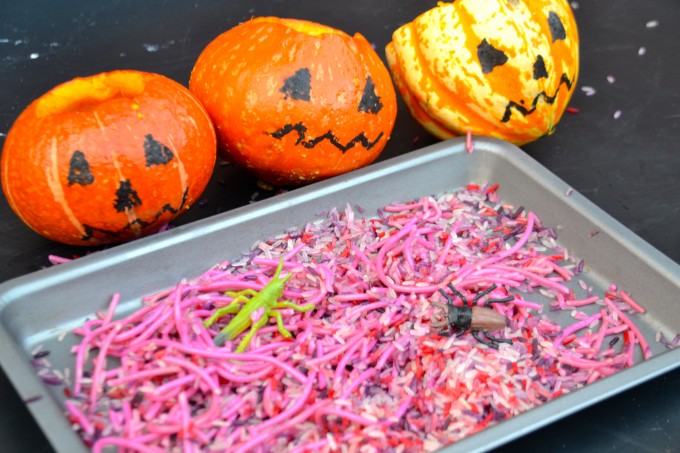 Halloween sensory tray filled with spaghetti and bugs.