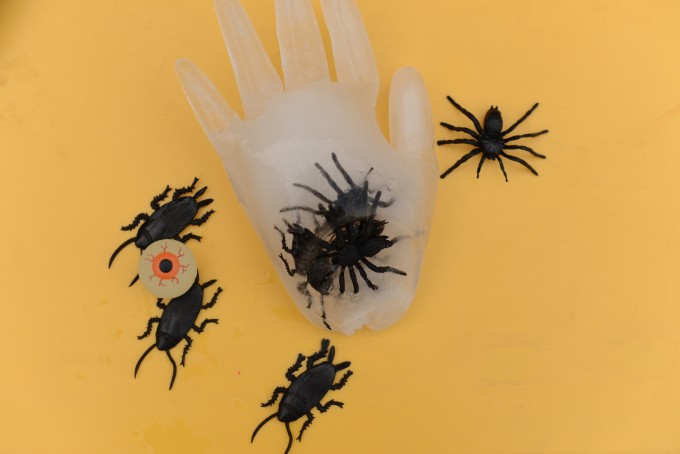 creepy frozen hands made using a glove and plastic spiders