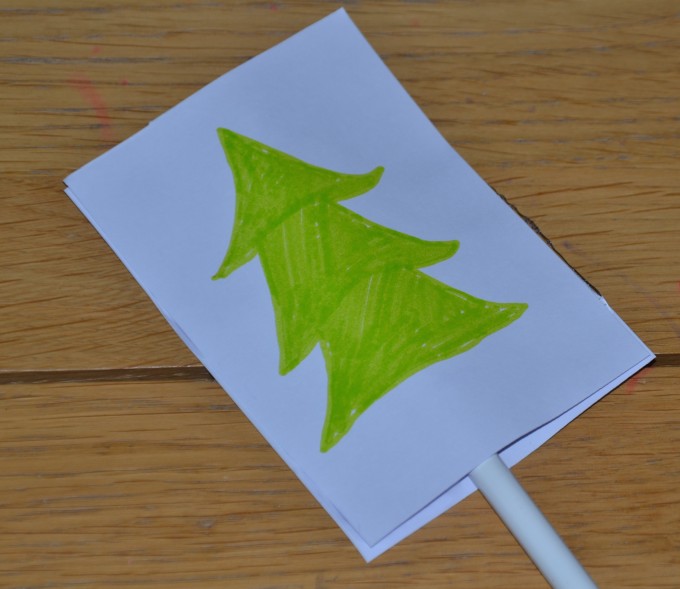 Image of a Christmas tree on a small piece of paper for making an optical illusion