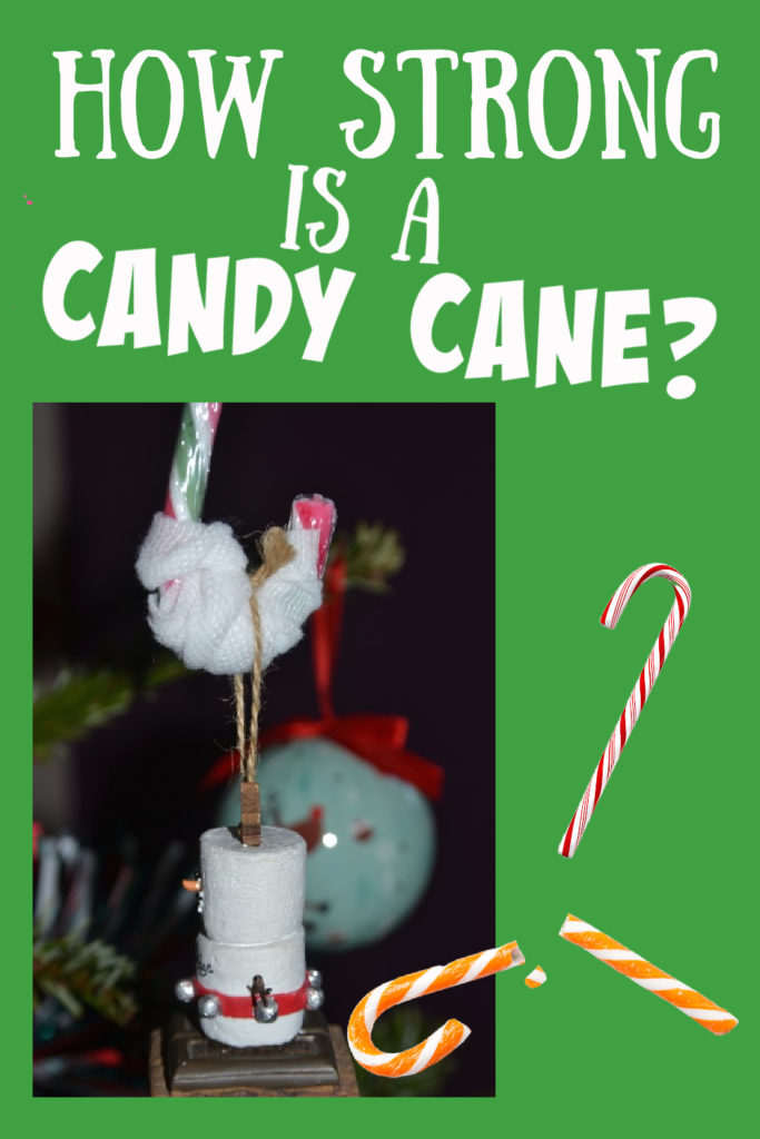 Image of a candy cane with a decoration hanging from it as a Christmas science challenge