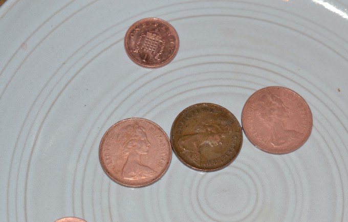 Coins cleaned with vinegar. 3 shiny and one that hasn't been cleaned.