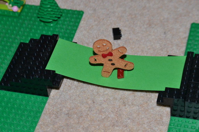 felt gingerbread man on a cardboard bridge for a science experiment