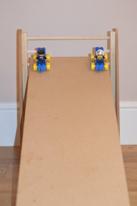 ramp with two DUPLO cars at the top ready to race down for a gradient and friction investigation