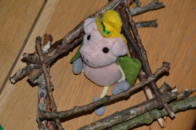 House built from sticks with a puppet pig inside for a STEM challenge