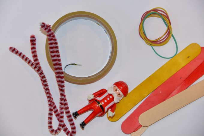 Pipe cleaners, tape, PlayMobil Santa, lolly sticks and elastic bands for a Santa Sleigh STEM challenge