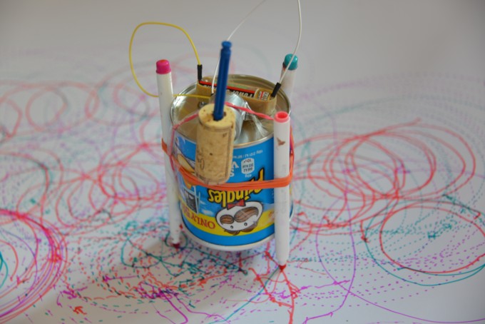 scribble bot drawing robot made with a motor, cork, battery, pens and a pringles pot!