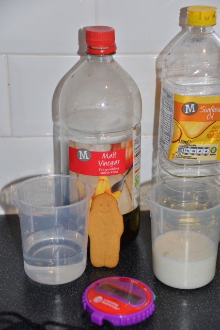 Image of a gingerbread man biscuit, vinegar and oil