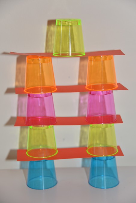 Build a tower challenge using small plastic cups and strips of cardboard