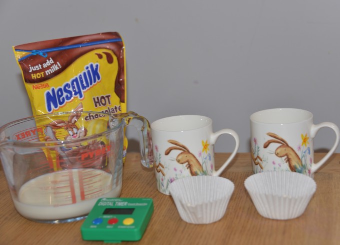 Hot chocolate ingredients, two mugs and a timer