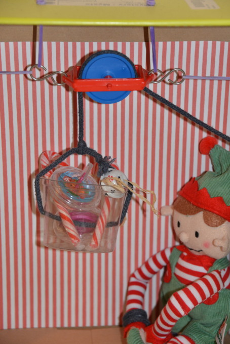 Mini pulley system inside a cardboard box for an elf stem challenge.