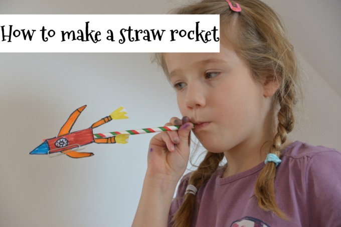 Girl blowing down a straw rocket as a space science activity