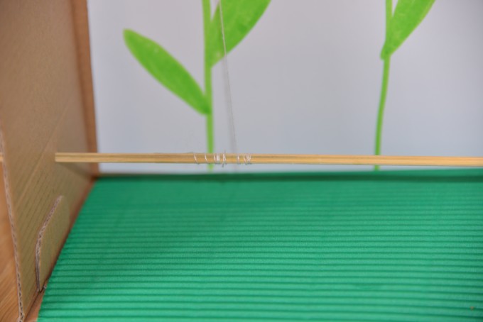 string wrapped around a skewer inside a shoebox for a magnet activity