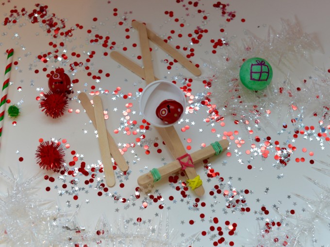 Catapult for Santa made with craft sticks for a festive STEM challenge
