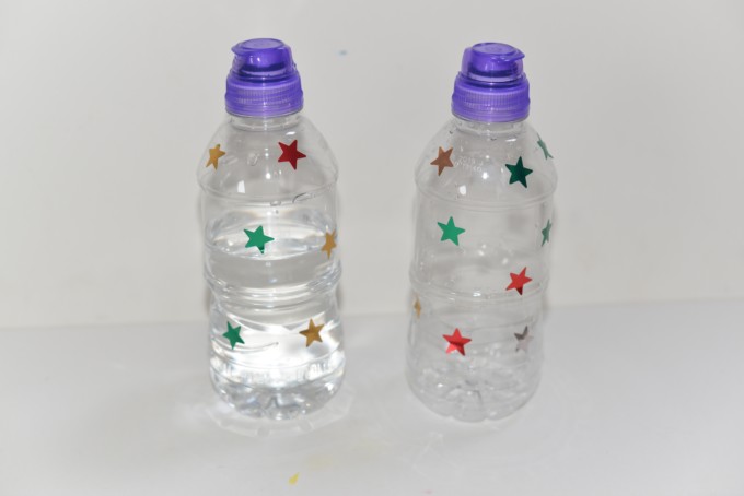 2 water bottles , one empty and one full of water for a Galilieo gravity experiment 