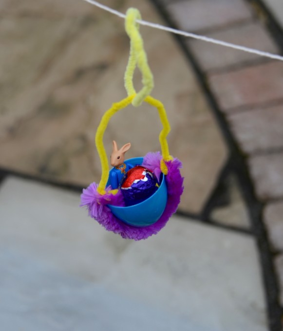 Easter Zip Wire - fun STEM Challenge for kids. Creme egg being transported down a zip wire in a small plastic egg