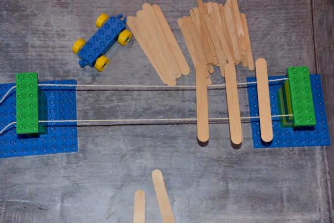 A bridge made from DUPLO, string and craft sticks for an engineering challenge.