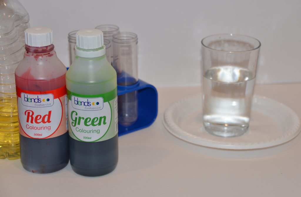 a glass of water and food colouring ready for a colourful water experiment