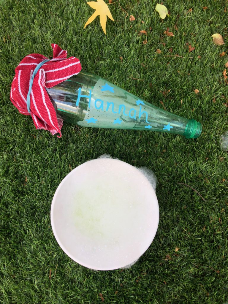 image of a bubble snake made with a plastic bottle and tea towel.