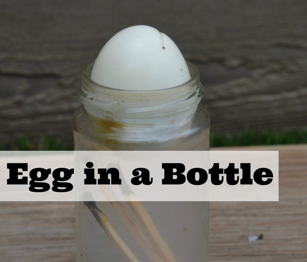 Egg in a bottle experiment. Image shows a boiled egg with the shell removed sitting on the top of a glass jar.