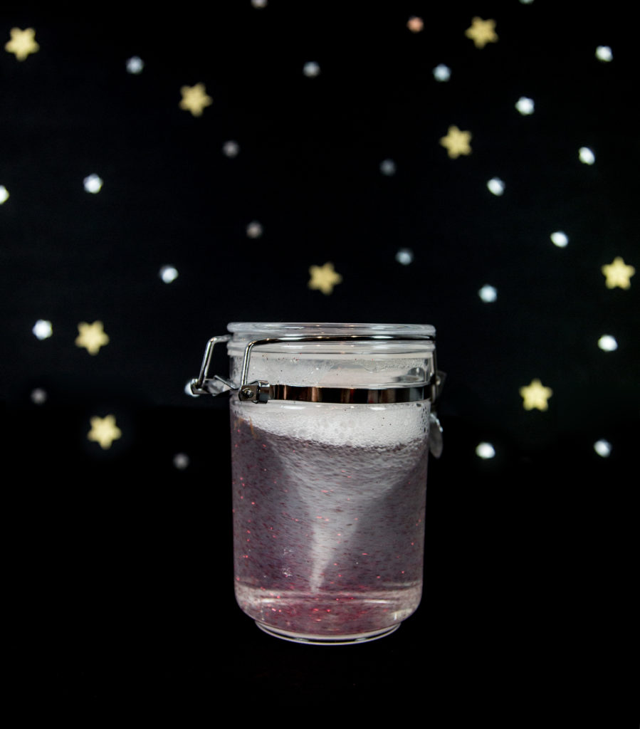 storm in a jar made with glitter, water and a plastic jar.