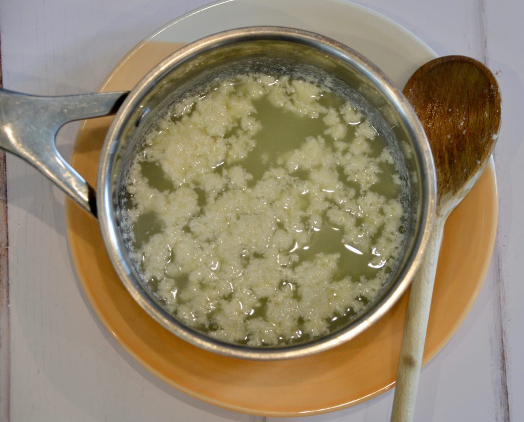 curds and whey from milk in a pan