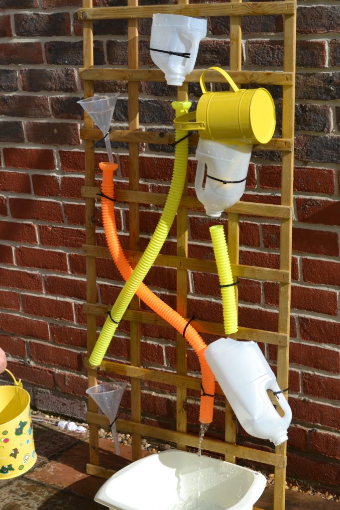 Easy homemade water wall made with colourful tubes and jugs
