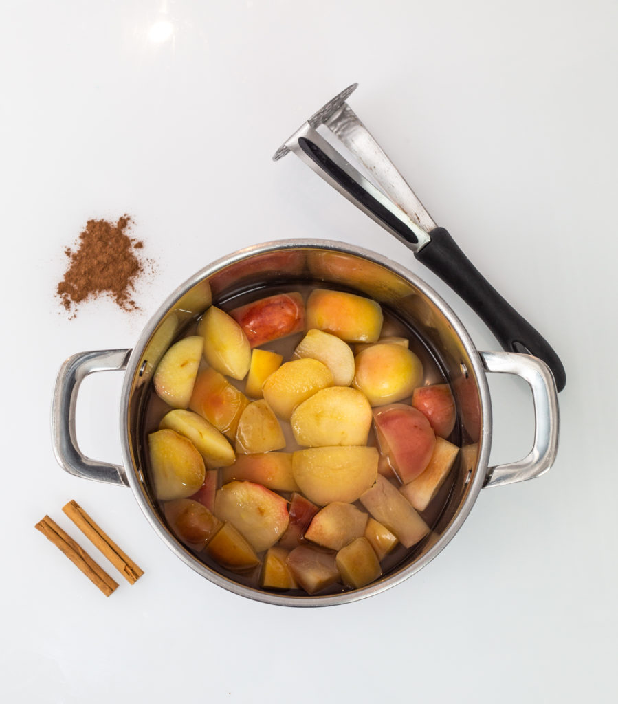 Pan with chopped apples inside ready for making spiced apple cider