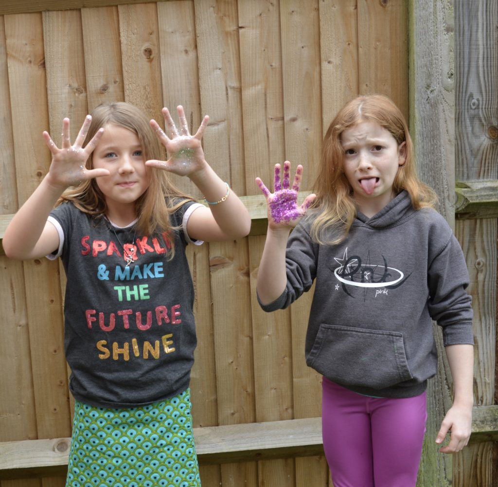 Handwashing activity - children with glitter on their hands