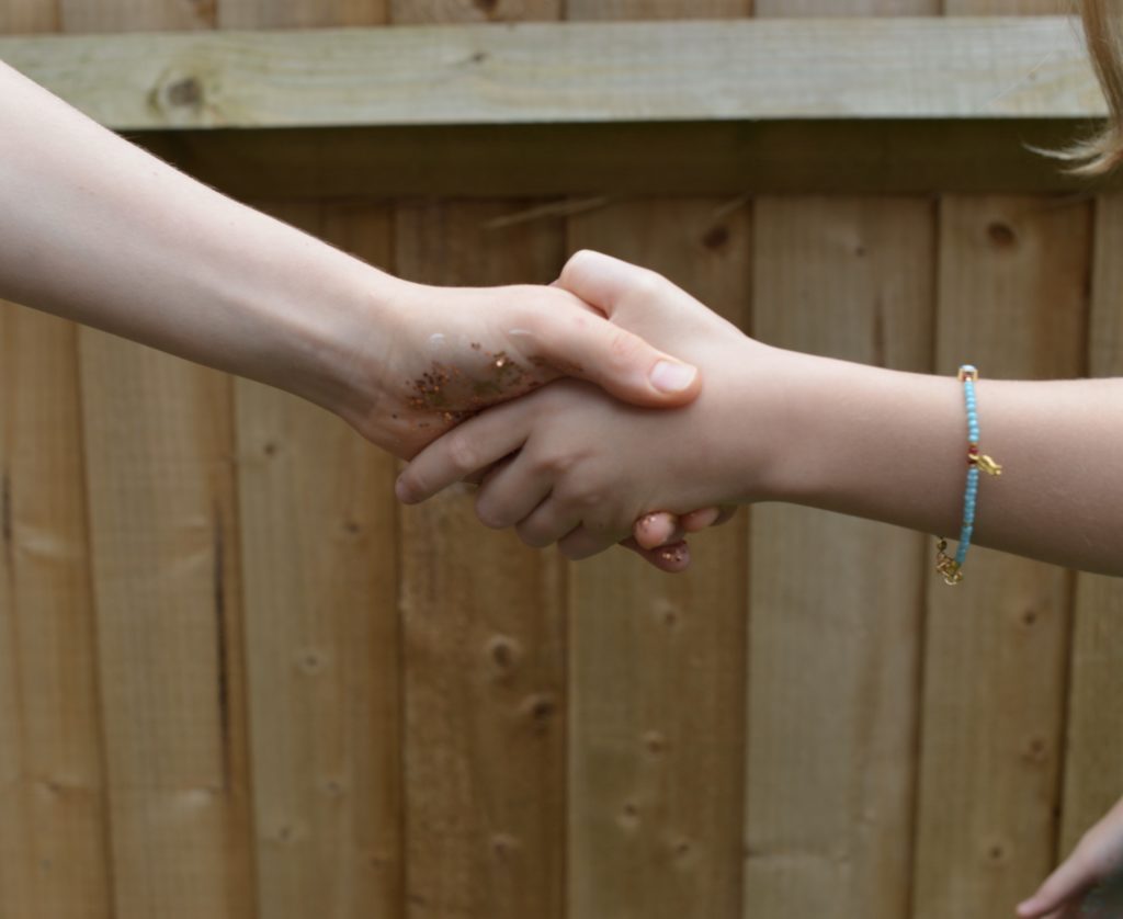Children shaking hands as part of a handwashing activity