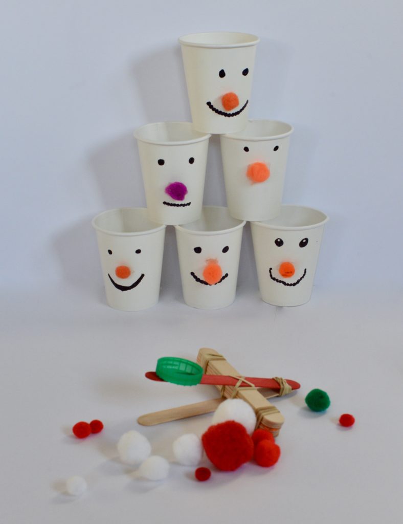 snowman themed catapult with a white paper cup snowman tower to knock over